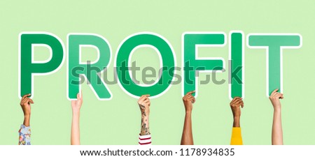 Hands holding up green letters forming the word profit