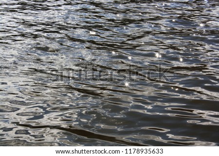 ripples on the water with glare, the reflection of the sun on the water