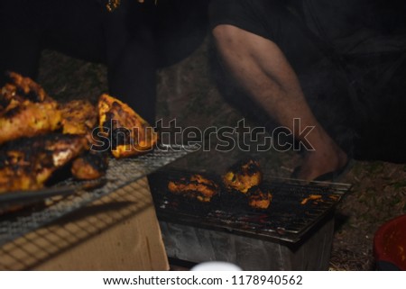 people grill the chicken