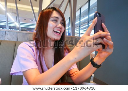women take the picture with selfie mode by smartphone in restaurant