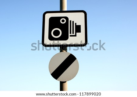 Speed camera warning and a national speed limit sign used to warn drivers on British highways and roads