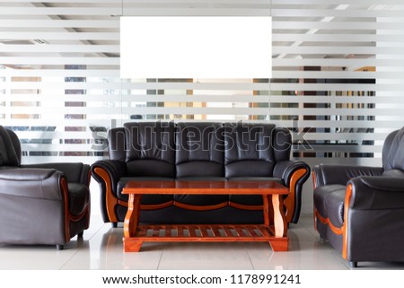 Blank Photo Picture Frame Billboard Advertisement Large White Ad Isolated Living Room Leather Couch Glass Wall Template Royalty-Free Stock Photo #1178991241