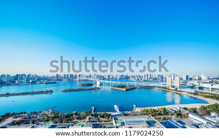 Asia Business concept for real estate and corporate construction - panoramic modern city skyline bird eye aerial view of Odaiba, tokyo tower & rainbow bridge under blue sky in Tokyo, Japan