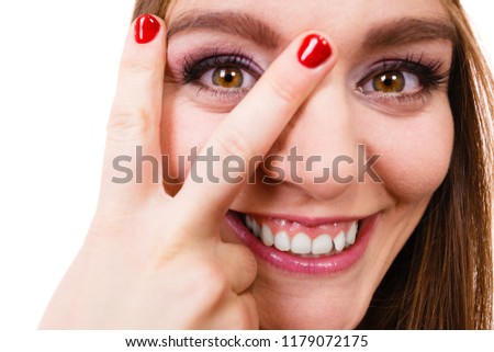 People, beauty concept. Beautiful girl with red nails. Young attractive lady has delicate make up and coloured nail. 