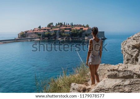 Beautiful young and happy female on vacation enjoying summer time on sea side. Woman on holiday having fun traveling.