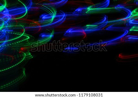 abstraction, arbitrary lines of light, red, blue and green, the movement of particles, atoms and photons, light in motion, the perfect combination of colors