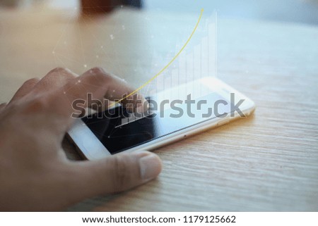 Business man hand working with  new modern smart phone or mobile and business strategy (graph)