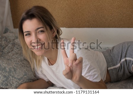 Happy woman in bed at home