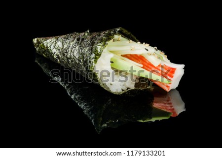 Temaki California sushi with surimi crab, avocado and cucumber on black background