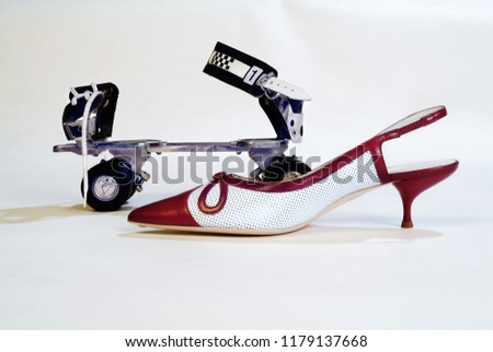 A roller skate and a high heel shoe on white background.