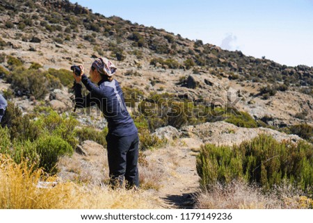 She is taking photos from high have many fog Kilimanjaro Mountain
 in Tanzania