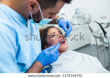 Beautiful young woman having dental treatment at dentist's office.  Royalty-Free Stock Photo #1179164752