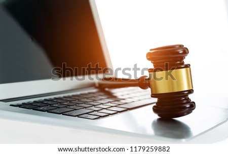 Judge gavel on laptop computer keyboard.