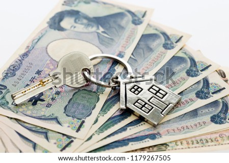 House key over japanese banknotes.
