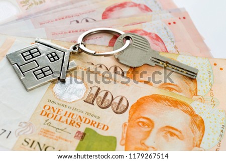 House key over singapore banknotes.