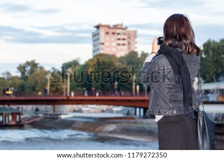 Beautiful Chinese Girl Taking a Picture of the City