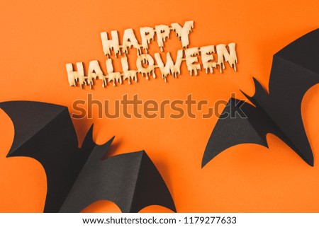Portrait of paper bats and Happy Halloween inscription