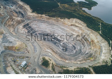 Opencast Mining Quarry for the Extraction of Ironstone Magnetite Ores. Located in Olenegorsk in Nothern Russia Royalty-Free Stock Photo #1179304573