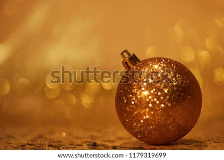 golden glittering christmas ball for decoration on tabletop with sequins