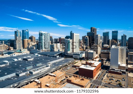 Modern and historic architecture meets together in a clash of new and old Denver , Colorado , USA downtown skyline Cityscape rises behind old brick buildings sunny afternoon
