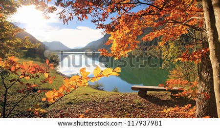 beautiful lake view in autumn, with a wooden bench