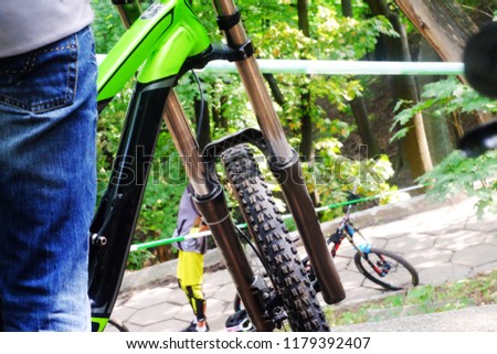 a man cyclist wearing gloves sits on a mountain bike before the race, the theme of cycling and mtb
