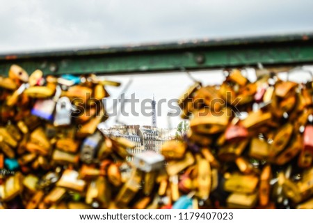 Locks in a bridge with the Eiffel Tower in the distance