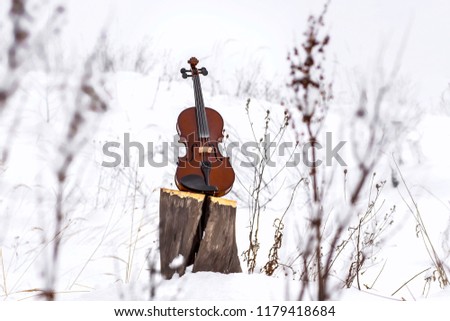Background with snow and violin. Royalty-Free Stock Photo #1179418684