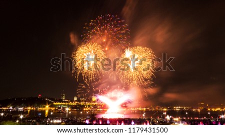 Bright orange fireworks during a summer festival in Quebec City, Canada.