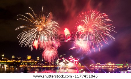 Bright pink and orange fireworks over the Saint-Lawrence River near Quebec City during a Canadian summer festival.