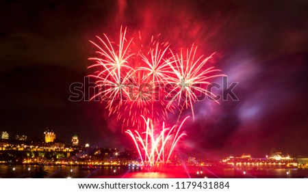 Bright red fireworks during a summer festival in Quebec City, Canada.