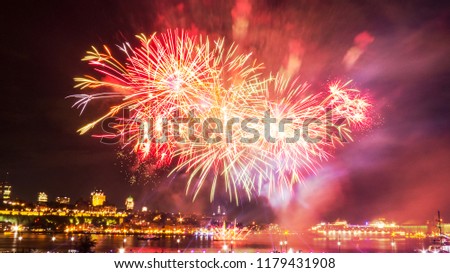 Big fireworks in front of Quebec City during a summer festival.