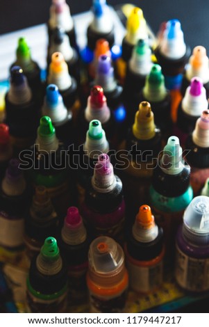 many professional bottles with colored ink for tattoos. tattoo parlor