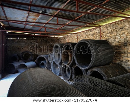 Rolls of metal meshes in a sieve factory.