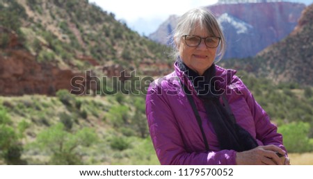 Closeup view of charming elder female enjoying nature and smiling for the camera