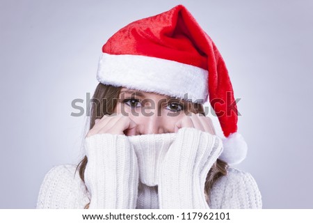 young woman covering herself with wool sweater