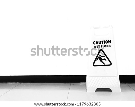 Wet floor caution signs in office. Black and white.