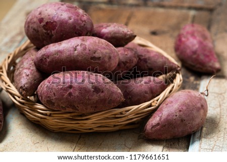 Sweet Potatoes Purple Colored on Wood Table background