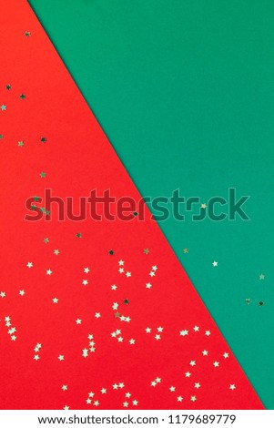 New Year or Christmas pattern flat lay top view Xmas holiday celebration red green paper golden sparkles confetti background. Template for greeting card your text design 2019