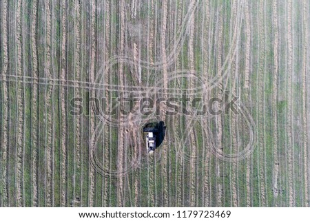 Combine harvester on the field. View from above.