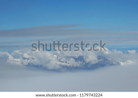 Cloudy sky with light cloud around the snow mountains