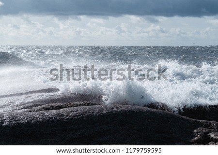 waves hit the rock