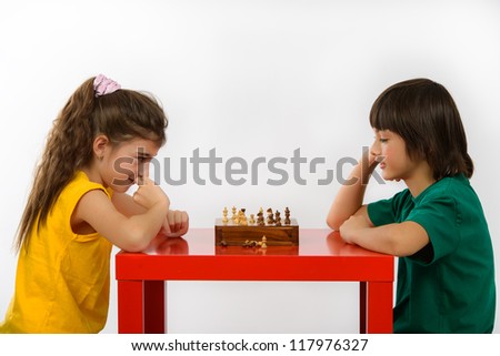 two children playing chess isolated on white background