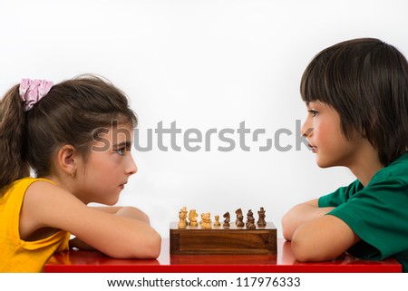 two children playing chess isolated on white background