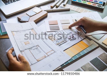 Architect designer Interior creative working hand drawing sketch plan blue print selection material color samples art tools Design Studio Royalty-Free Stock Photo #1179850486