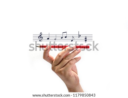 Hand held pencil with note music isolated on white background, Creativity