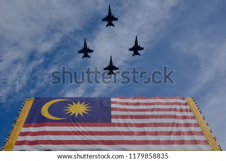 Jet fighter was cross over the Malaysia flag this photo was shoot at magic moment with wide angle lens and available light