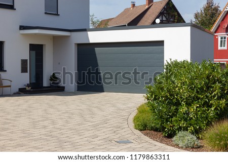 modern carport and way details in south german bavaria countryside new village area Royalty-Free Stock Photo #1179863311