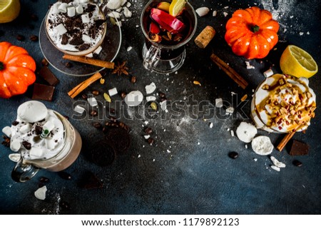 Autumn winter warm drinks, hot chocolate, pumpkin latte, caramel and peanut coffee latte, mulled wine, cozy dark background copy space top view