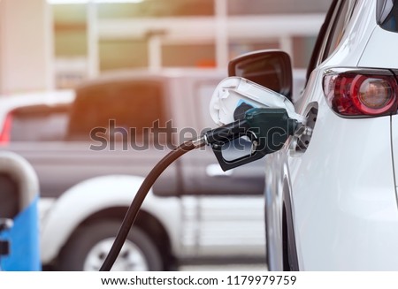Close up of fuel monitoring system refueling a petroleum to vehicle at gas station. Royalty-Free Stock Photo #1179979759